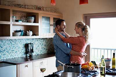 Buy stock photo Shot of a couple spending some time together while cooking