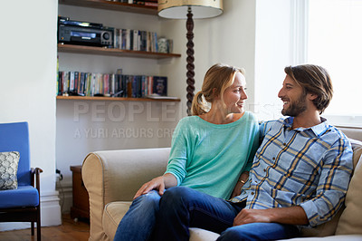 Buy stock photo Shot of a young couple relaxing on a sofa at home