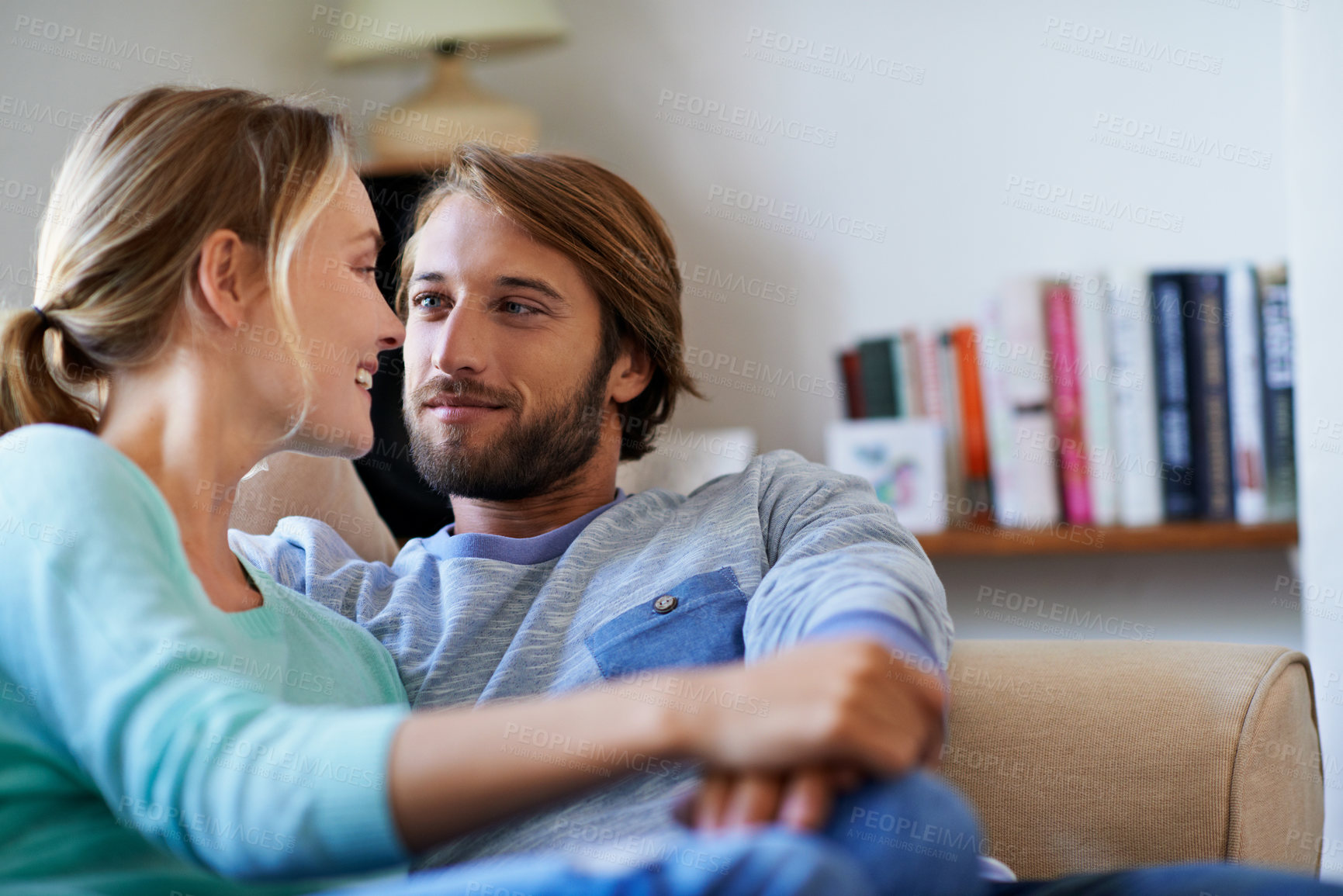 Buy stock photo Couple, relax and romance on couch in house, love and smile with partner in living room and bonding. Happy people, care and connection with spouse in lounge, break and relationship commitment in home