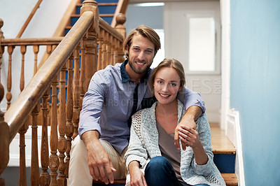 Buy stock photo Shot of an affectionate couple sitting on the staircase at home