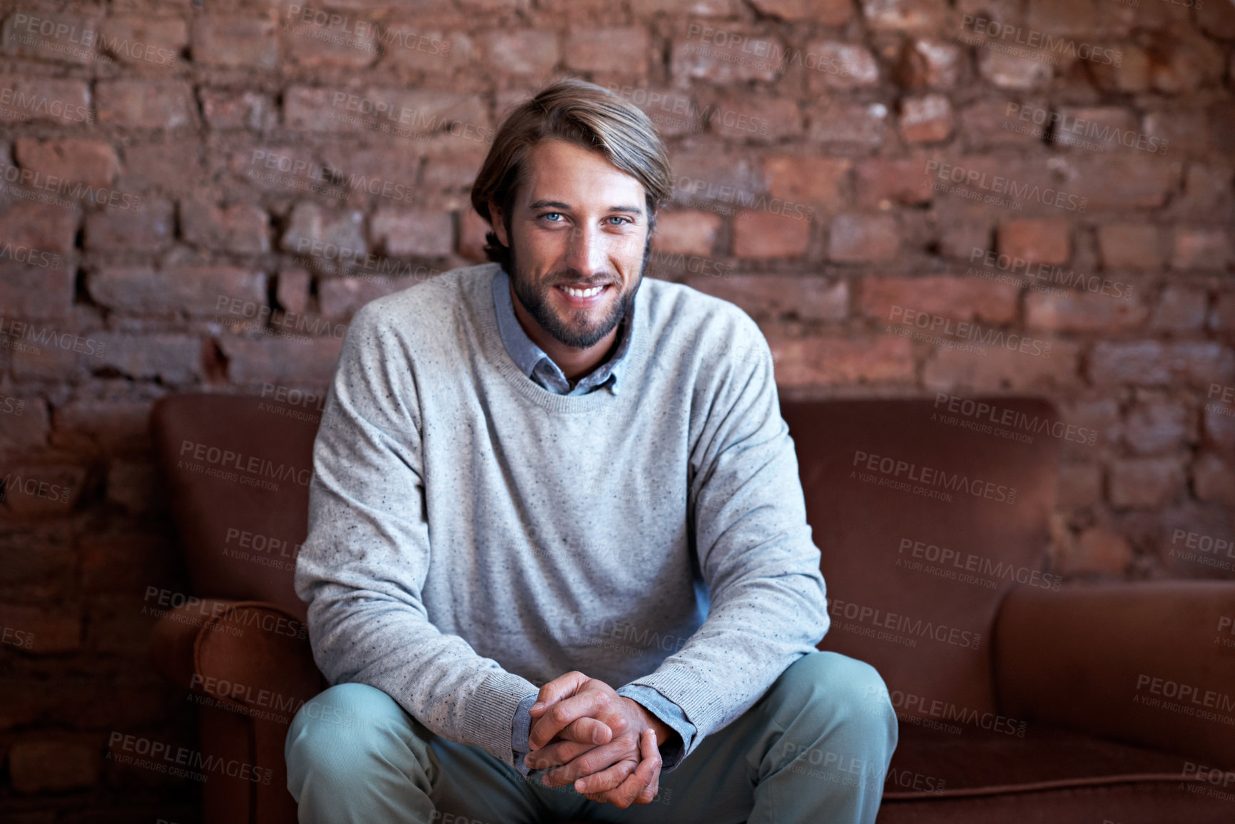 Buy stock photo Portrait of a young man sitting on a couch