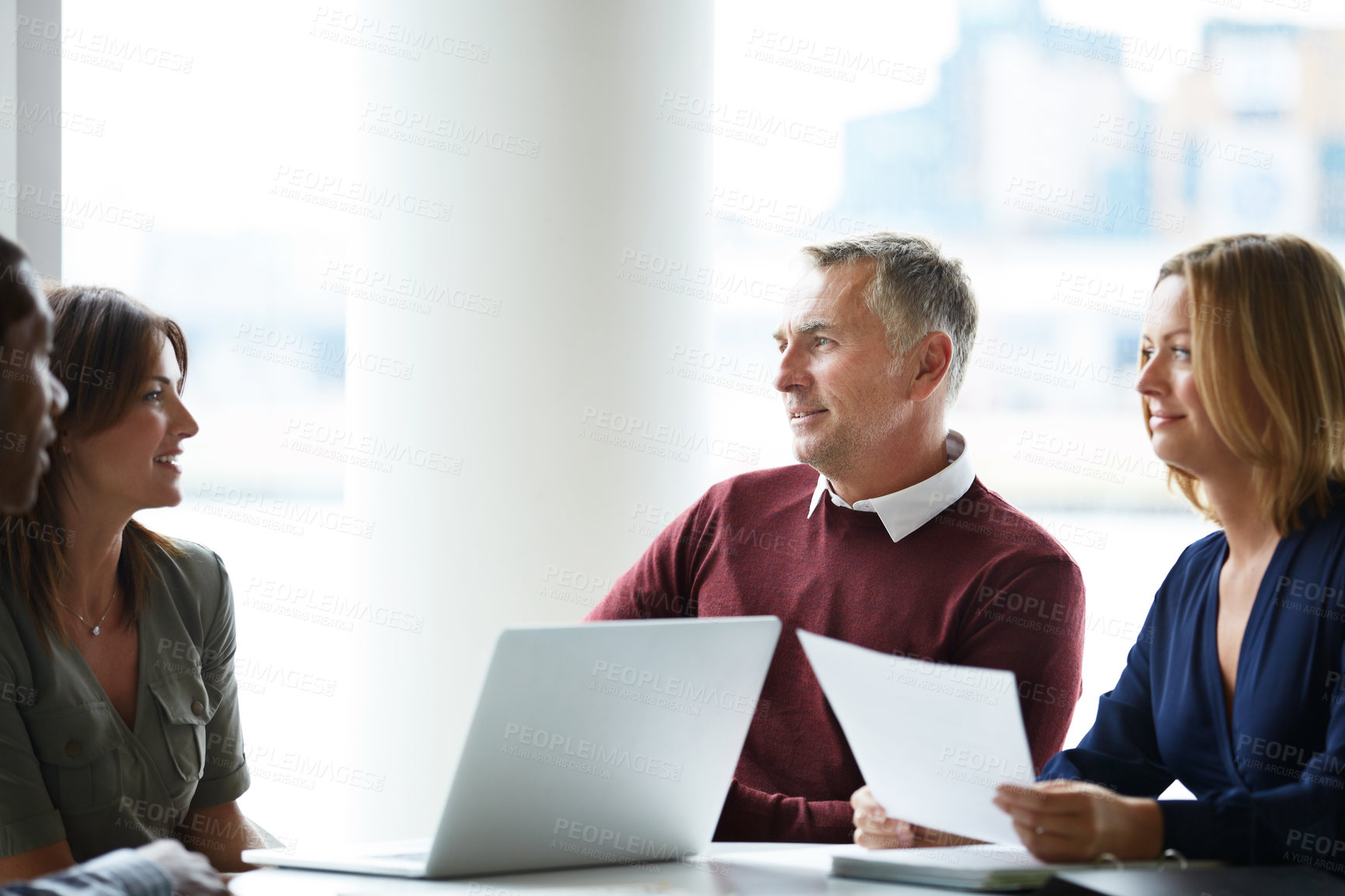Buy stock photo Shot of a group of colleagues talking together in a modern office