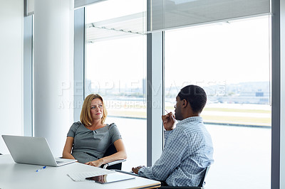 Buy stock photo Shot of two colleagues having a meeting in an office