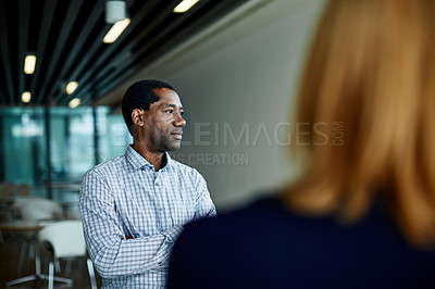 Buy stock photo Shot of two colleagues talking together in an office