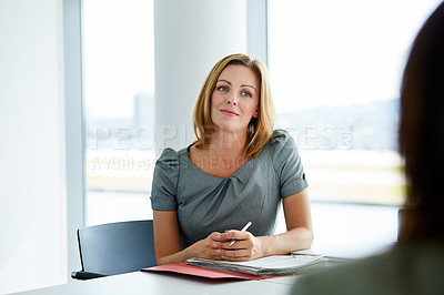 Buy stock photo Shot of two colleagues talking together in an office