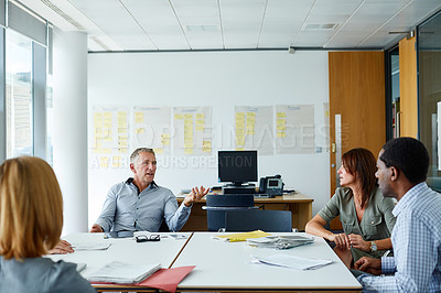 Buy stock photo Shot of a group of coworkers having a meeting in an office
