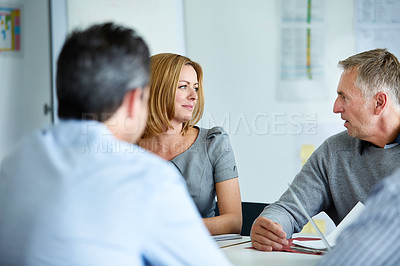 Buy stock photo Shot of a group of colleagues talking together in a modern office