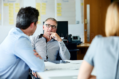 Buy stock photo Shot of a group of colleagues talking together in a modern office