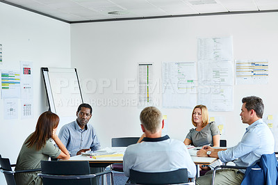Buy stock photo Shot of a group of colleagues talking together in a modern office