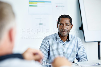 Buy stock photo Shot of two colleagues talking together in a modern office