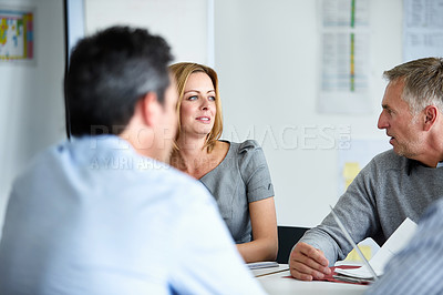 Buy stock photo Shot of a group of colleagues talking together in a modern office