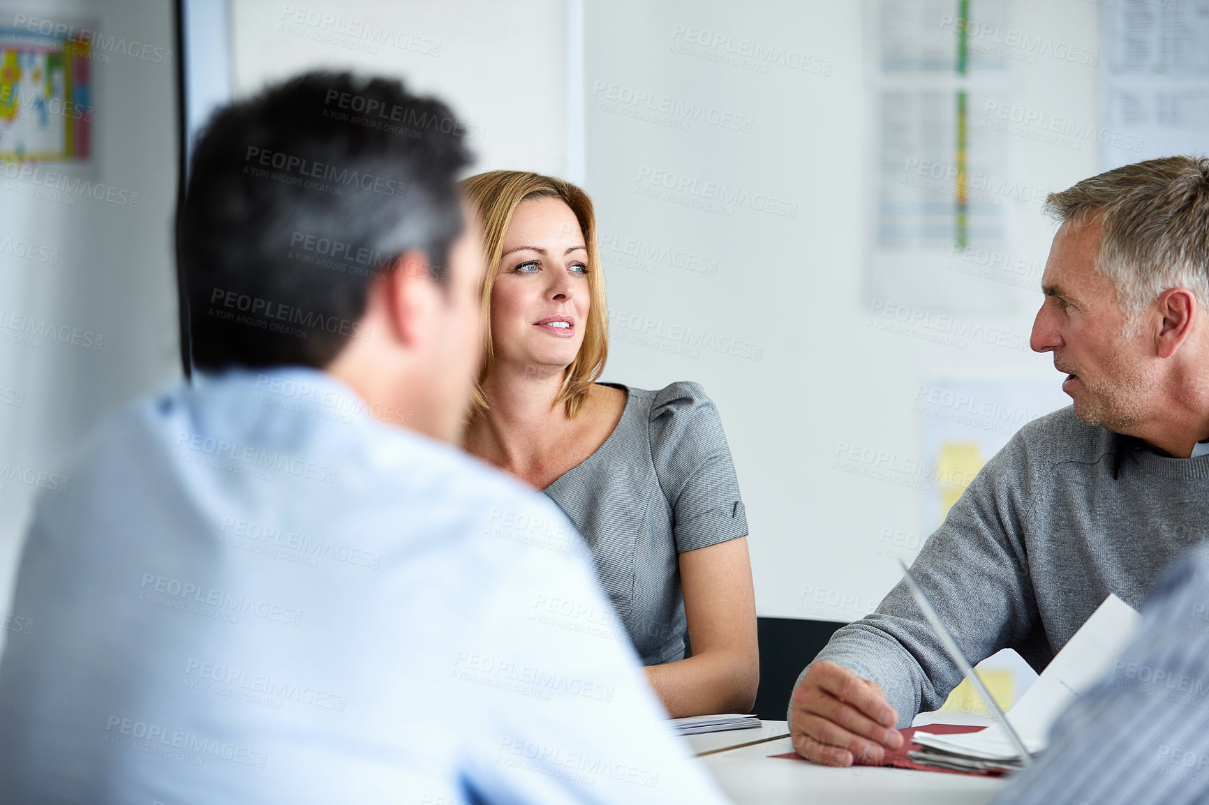 Buy stock photo Shot of a group of colleagues talking together in a modern office