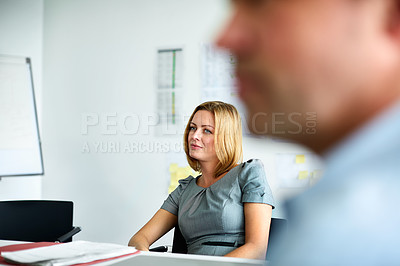 Buy stock photo Shot of two colleagues talking together in a modern office