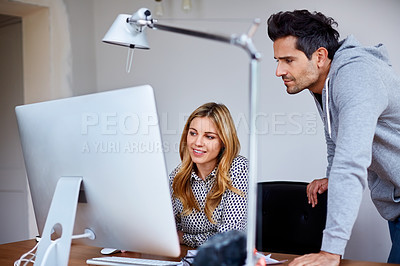 Buy stock photo Shot of a young couple working together in their home office