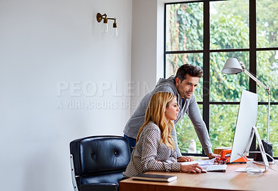 Buy stock photo Shot of a happy young couple working together in their home office