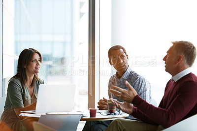 Buy stock photo Shot of a group of coworkers having a meeting in an office