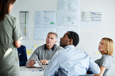 Buy stock photo Shot of a businesswomen giving a presentation to a group of colleagues in an office