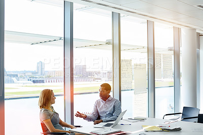 Buy stock photo Shot of two colleagues having a meeting in an office