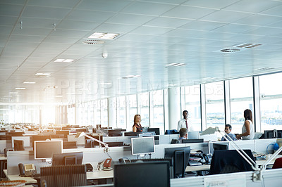 Buy stock photo Shot of a group of businesspeople talking together in an office