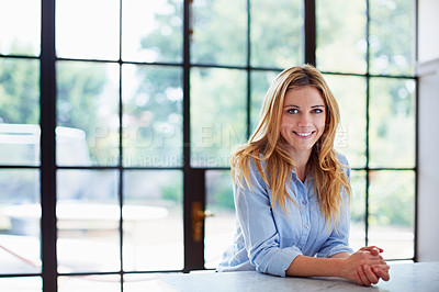 Buy stock photo Portrait of a young woman leaning on her counter at home