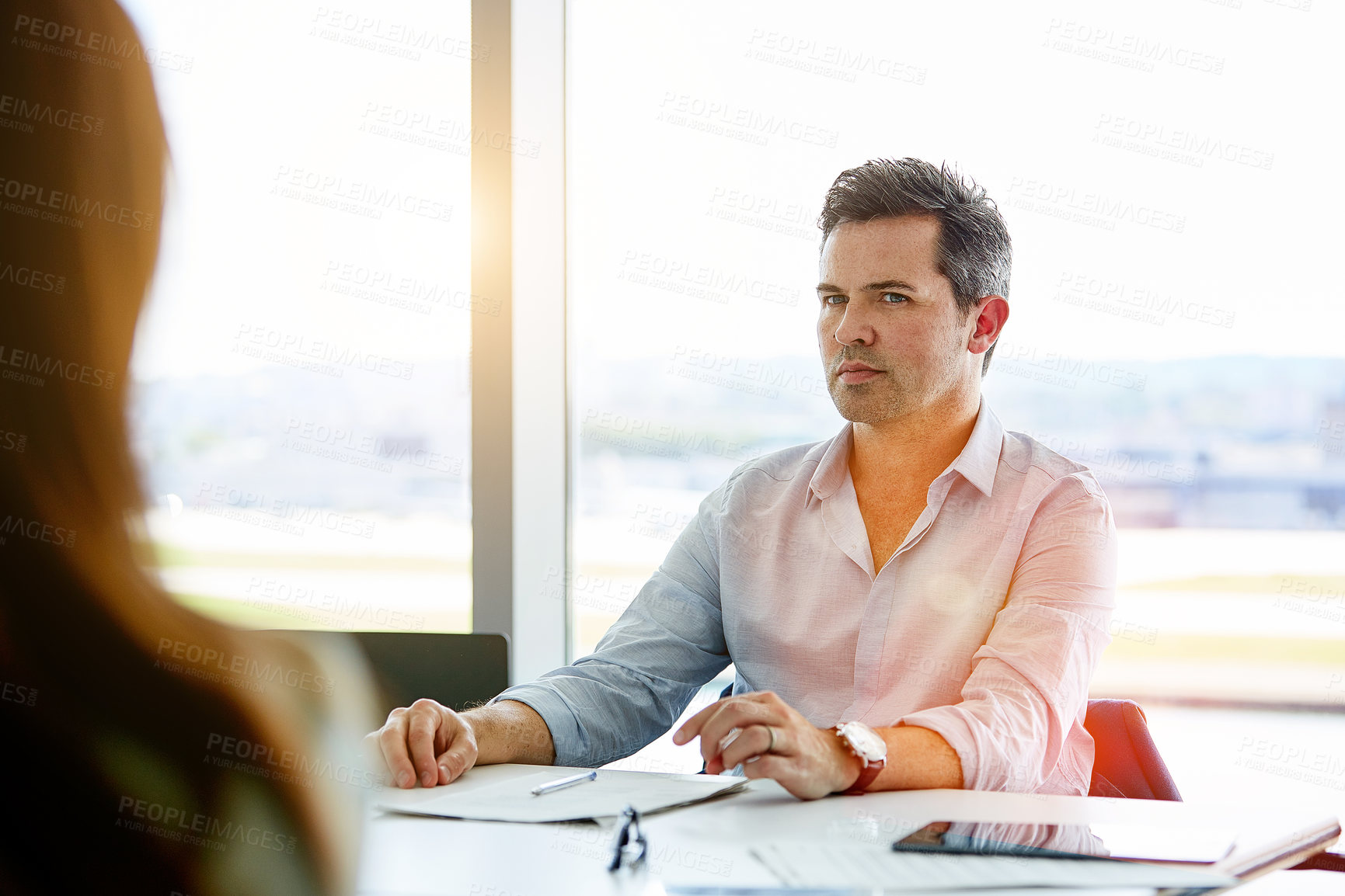 Buy stock photo Shot of two coworkers talking together while sitting in an office