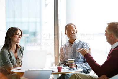 Buy stock photo Shot of a group of smiling coworkers having a meeting in an office