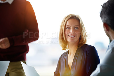 Buy stock photo Shot of a group of coworkers talking together while sitting in an office