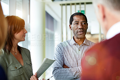 Buy stock photo Shot of a group of professional businesspeople talking in the office