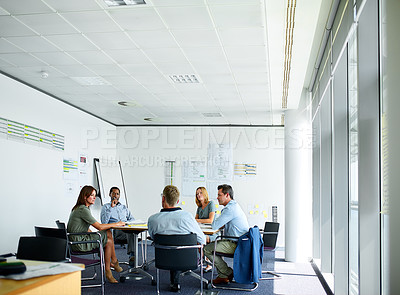 Buy stock photo Shot of a group of professional businesspeople meeting in the boardroom