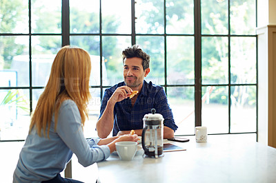 Buy stock photo Shot of a young couple having breakfast together at home