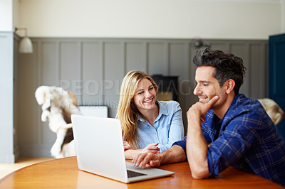 Buy stock photo Shot of a young couple using a laptop together at home