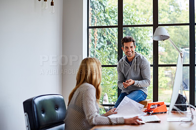 Buy stock photo Shot of a young couple working together in their home office