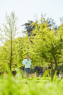 Buy stock photo Full length portrait of an attractive and athletic young sportswoman out for a jog in the park