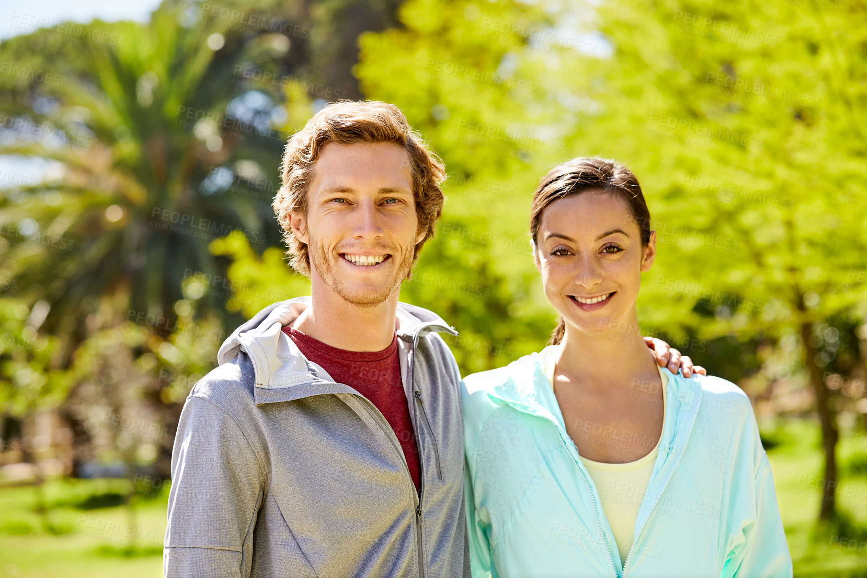 Buy stock photo Couple, portrait and runners with a smile outdoor in nature for fitness, healthy relationship and love. Man, woman and hug in park for workout, cardio routine and exercise for wellness in summer
