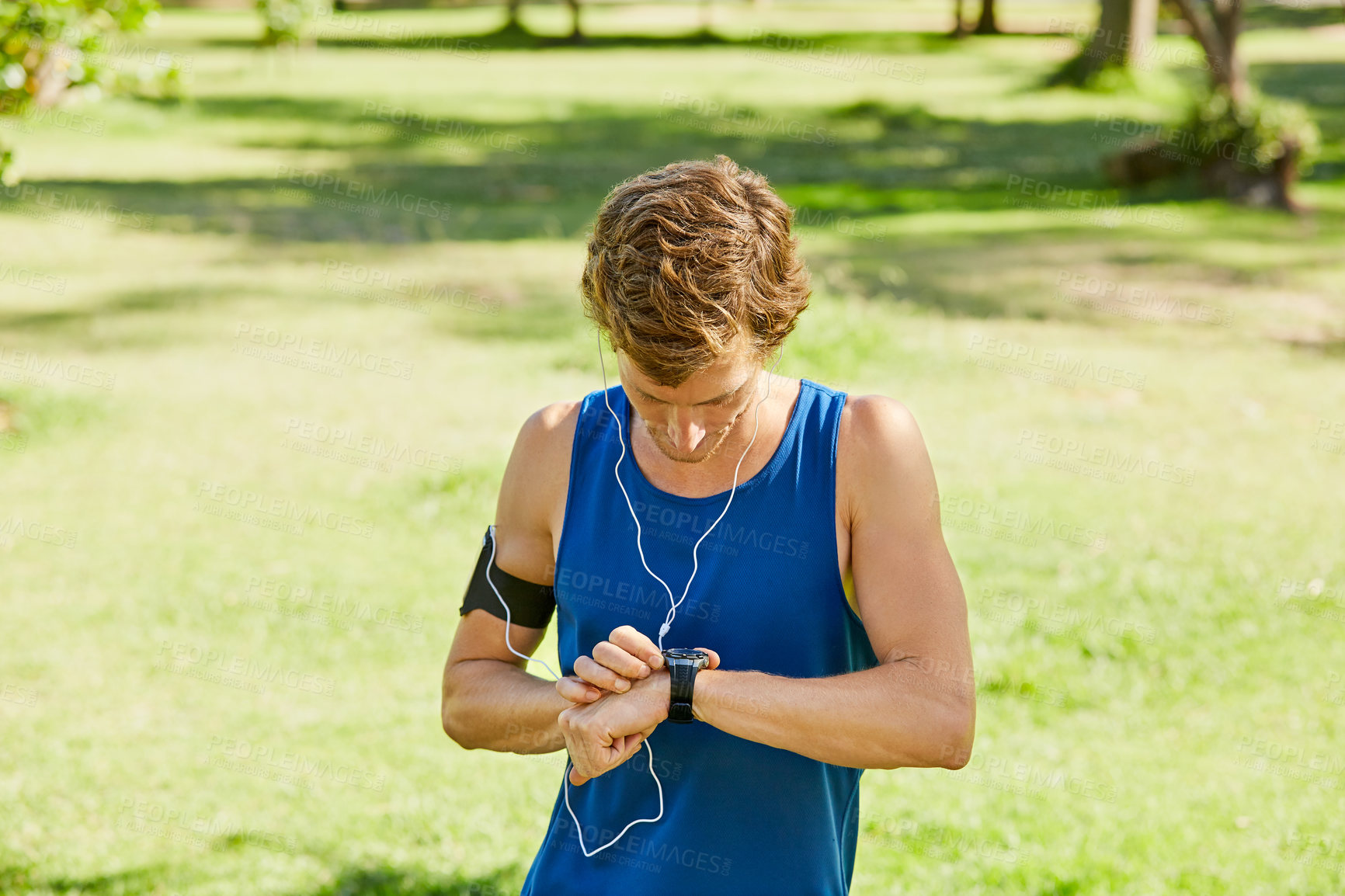 Buy stock photo Runner, man and smart watch in park with earphones, monitor heart rate and fitness app for workout. Space, person and check wearable tech outdoor with step tracker, music playlist and exercise timer.