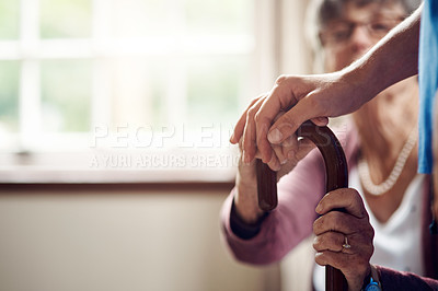 Buy stock photo Cropped shot of a nurse caring for a senior patient with a walking stick at home