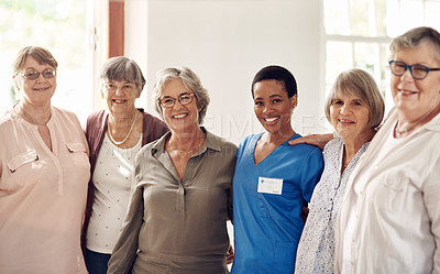 Buy stock photo Cropped portrait of an attractive young nurse standing with her senior patients in the living room of a nursing home