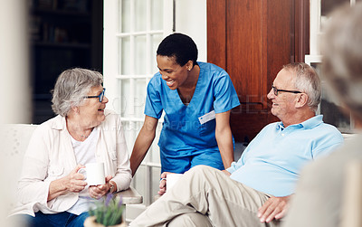 Buy stock photo Cropped shot of an attractive young nurse bonding with her senior patients during a day out on the veranda