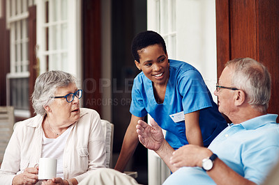 Buy stock photo Cropped shot of an attractive young nurse bonding with her senior patients during a day out on the veranda