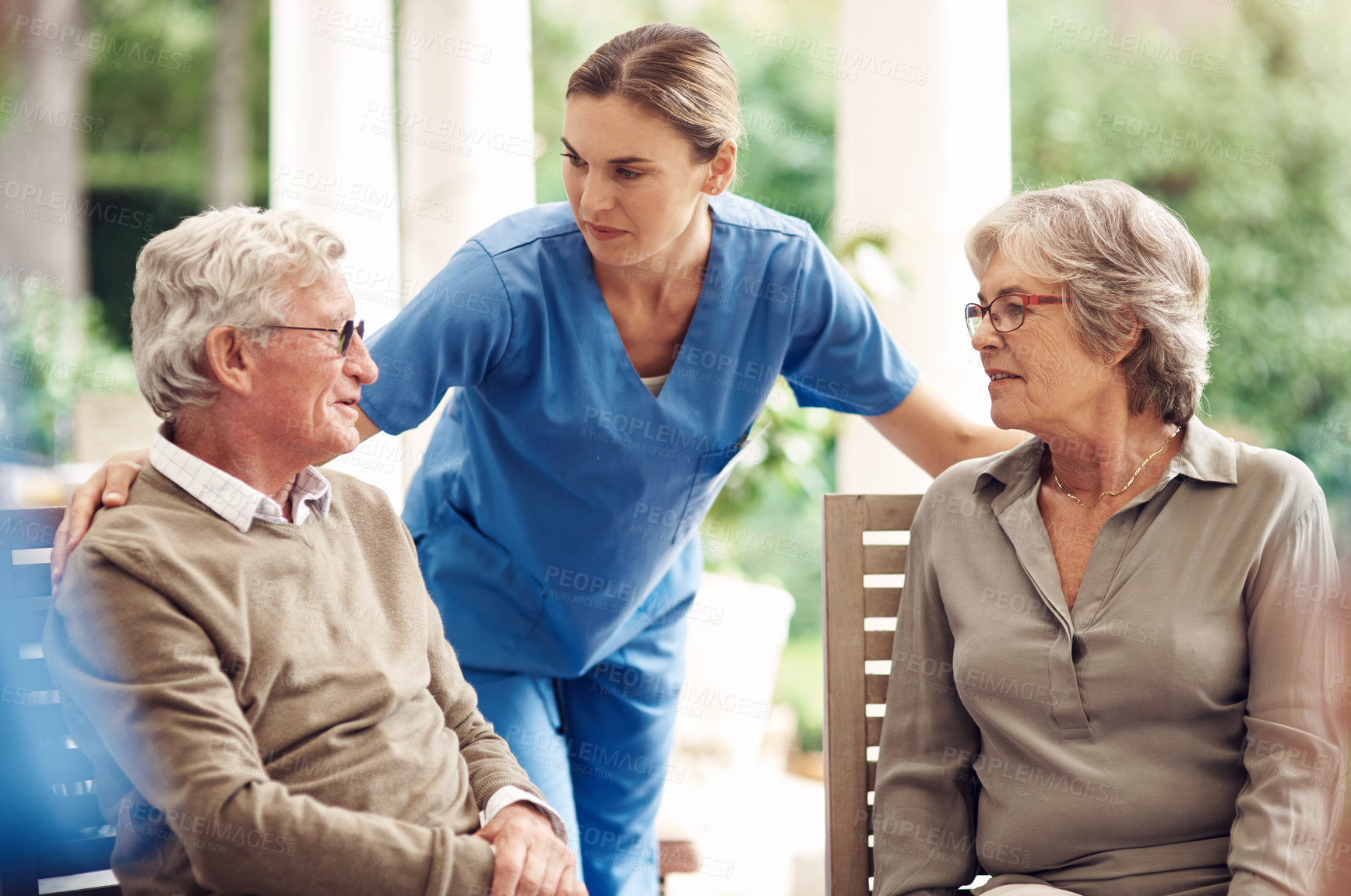 Buy stock photo Cropped shot of an attractive young nurse bonding with her senior patients during a tea party