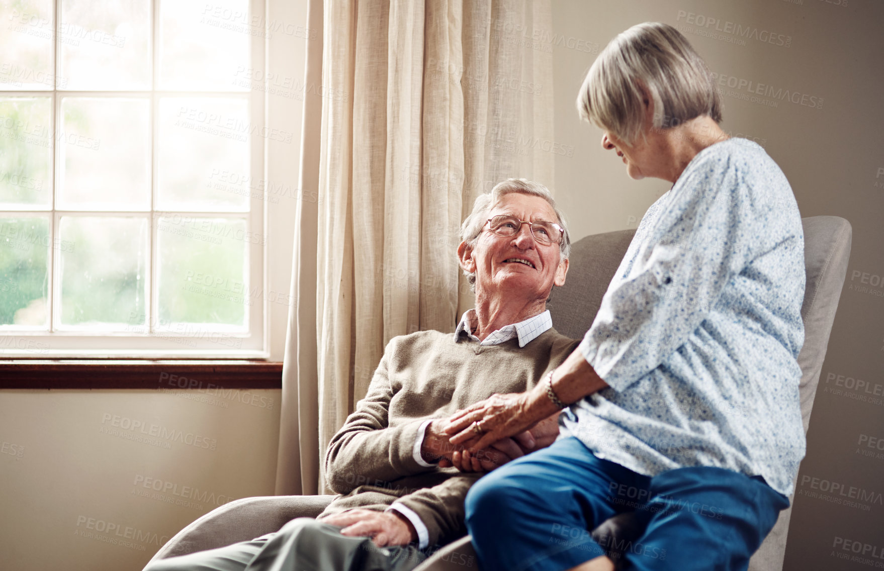 Buy stock photo Happy, couch and senior couple holding hands for talking, bonding and commitment by window. Retirement, home and elderly man and woman with affection for care, loving relationship and communication
