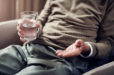 Buy stock photo Cropped shot of a senior man taking his medication with a glass of water