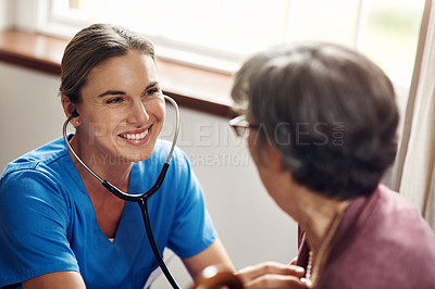 Buy stock photo Shot of a nurse examining a senior woman with a stethoscope at home