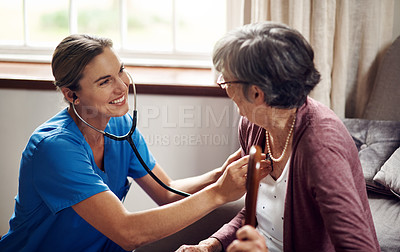 Buy stock photo Shot of a nurse examining a senior woman with a stethoscope at home