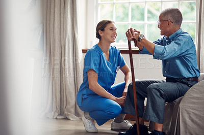 Buy stock photo Shot of a senior man being cared for by a young nurse at home