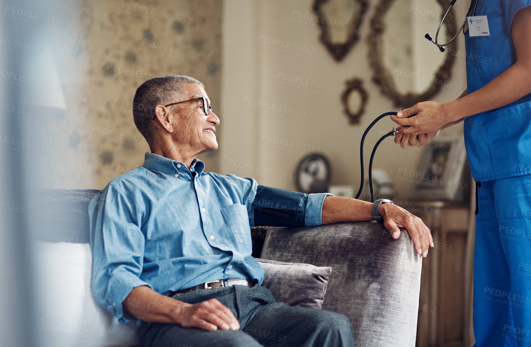 Buy stock photo Shot of a senior man getting his blood pressure measured during a checkup with a nurse at home