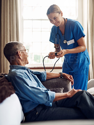 Buy stock photo Shot of a senior man getting his blood pressure measured during a checkup with a nurse at home