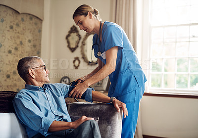 Buy stock photo Shot of a senior man getting his blood pressure measured during a checkup with a nurse at home