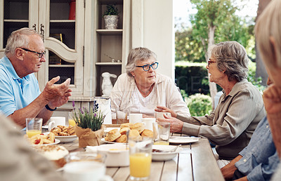 Buy stock photo Cropped shot of a group of senior citizens sitting together and enjoying a tea party outdoors