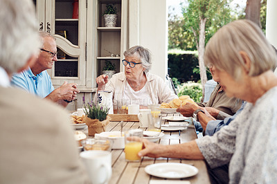 Buy stock photo Cropped shot of a group of senior citizens sitting together and enjoying a tea party outdoors
